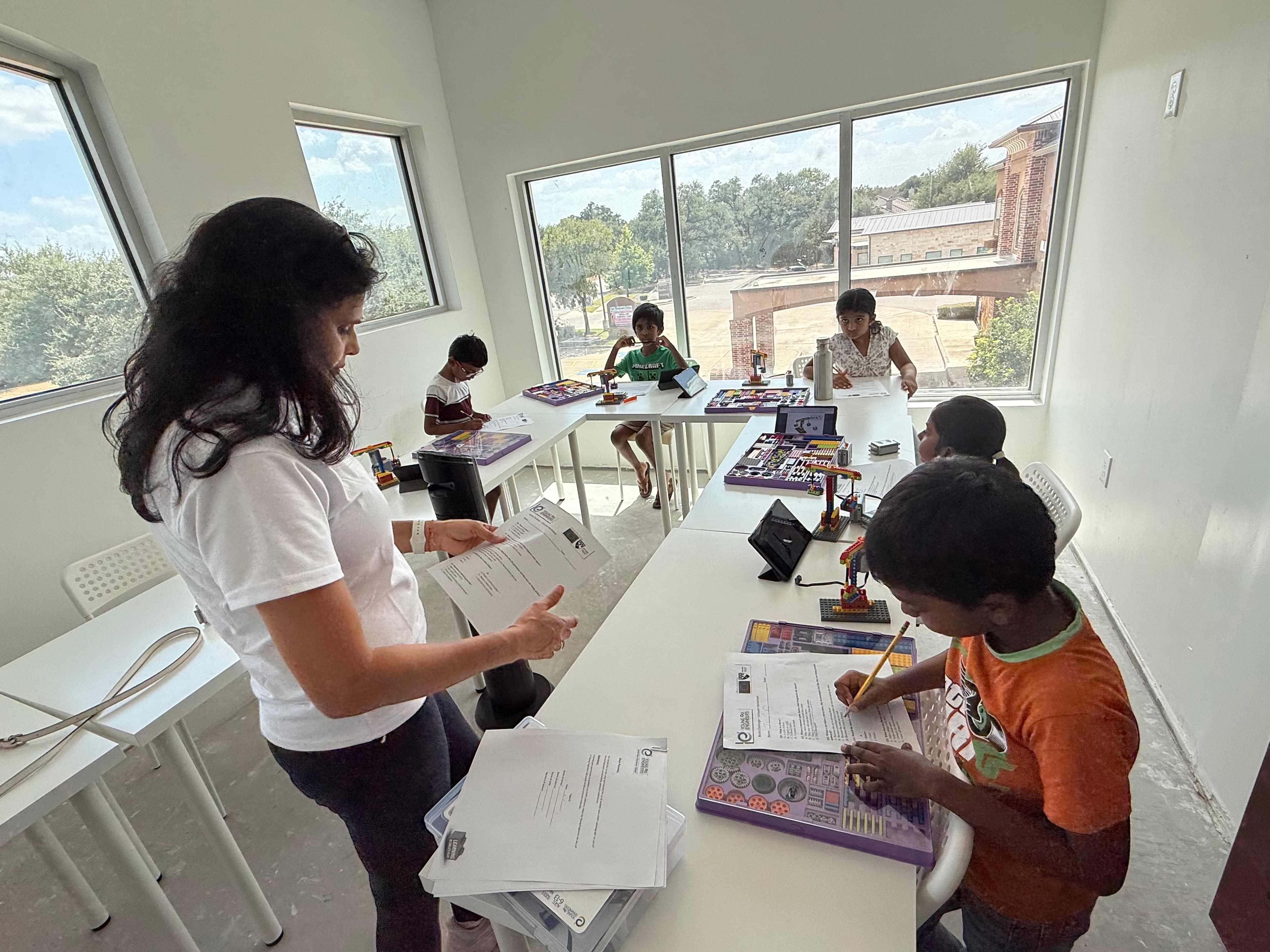 An instructor working through a build with students
